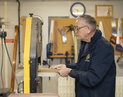A Maintenance man is Cutting The Mortise And Tenon Joint For Scupper Board in the workshop. 