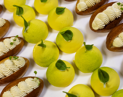 A selection of sweet treats, cream buns and lemon pastries. 