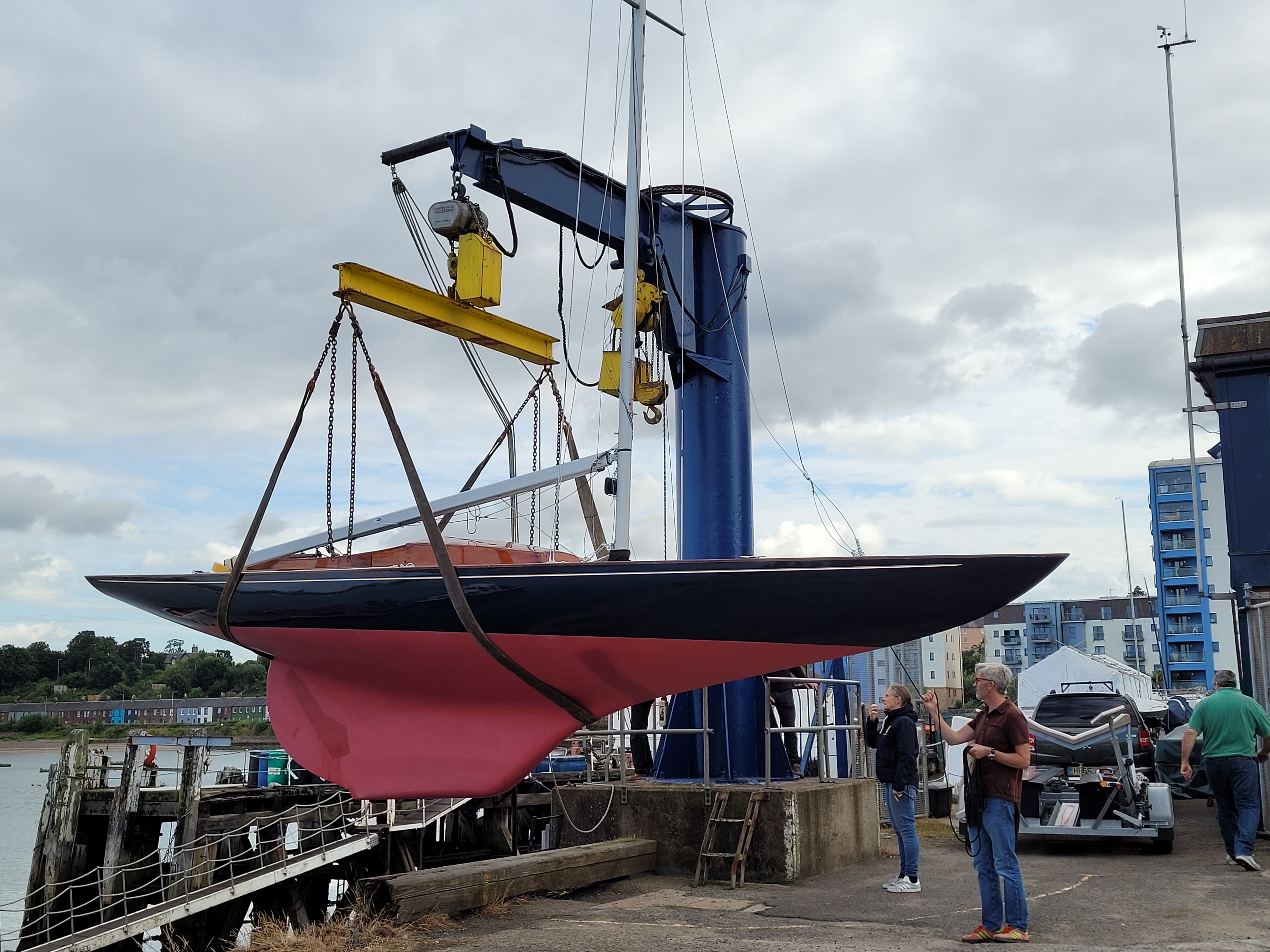 A small boat being lifted by a crane