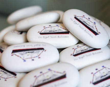 A pile of white erasers with an illustration of The Royal Yacht Britannia on them.