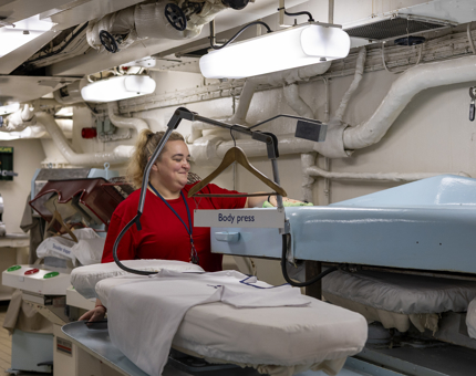 A Housekeeper in Britannia's Laundry cleaning. 