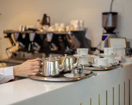 On the bar in the Royal Deck Tearoom, there are trays of drinks ready to be served. 