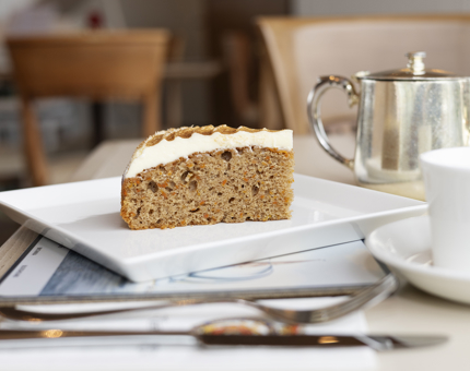 A slice of carrot cake and pot of tea in the Royal Deck Tearoom, The Royal Yacht Britannia. 