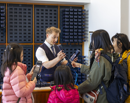 A Visitor Assistant providing visitors with our complimentary audio guide at Britannia's Visitor Centre.