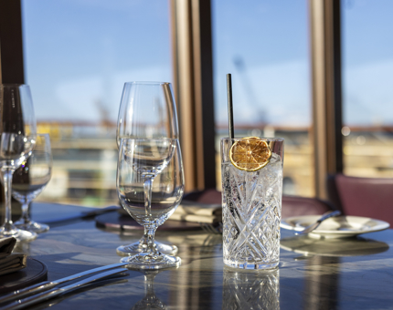 A G&T on a table in Fingal's Lighthouse Restaurant. Through the window you can see the Port of Leith. 