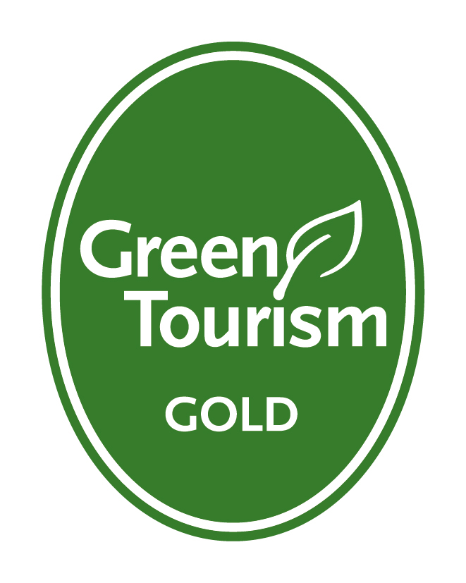 Green circle logo Gold in white 