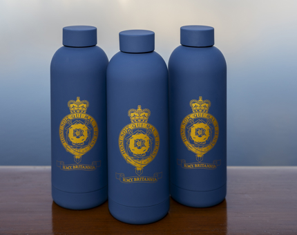 Three blue water bottles with a gold Britannia crest. 