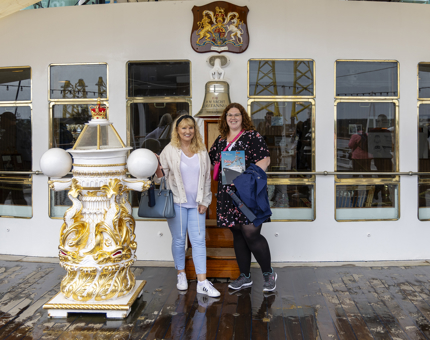 Britannia is an all-weather attraction. Two Visitors at the Bell with a guide book on the Verandah Deck. 