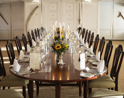 The table in the State Dining Room is set for an evening dinner on board.