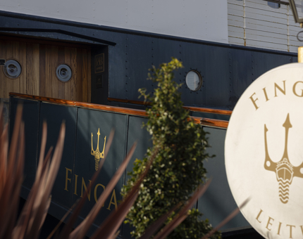 The entrance to Fingal Hotel, there is a perry buoy with a with cover featuring Fingal's trident logo in gold. 
