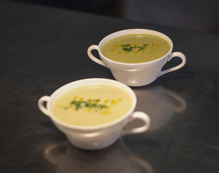 Two bowls of cheddar and courgette soup. 