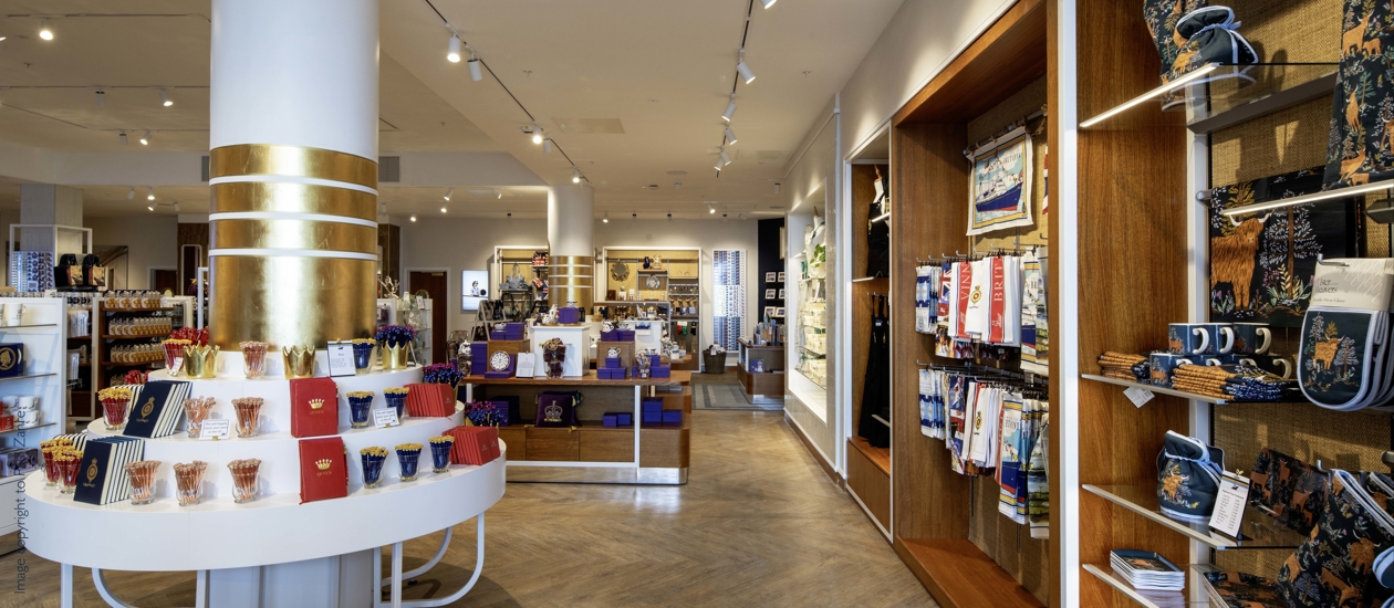 Inside the new Britannia Shop. There are many different displays included tables, a round pillar with shelves and wall-mounted displays containing souvenirs and gifts. 